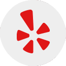 Red stylized flower-shaped logo with five petals on a white circular background, representing expert Wisconsin garage door repair and installation services.